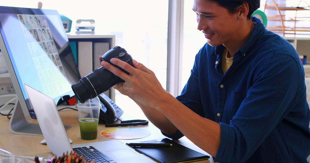 Photographer Reviewing Images on Camera at Office Desk - Free Images, Stock Photos and Pictures on Pikwizard.com