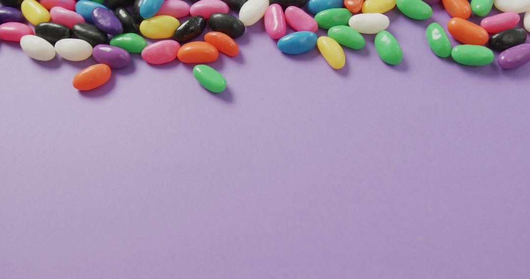 Colorful Assortment of Jelly Beans on Purple Background - Free Images, Stock Photos and Pictures on Pikwizard.com