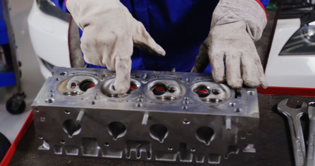 Auto Mechanic Inspecting Cylinder Head in Workshop - Free Images, Stock Photos and Pictures on Pikwizard.com