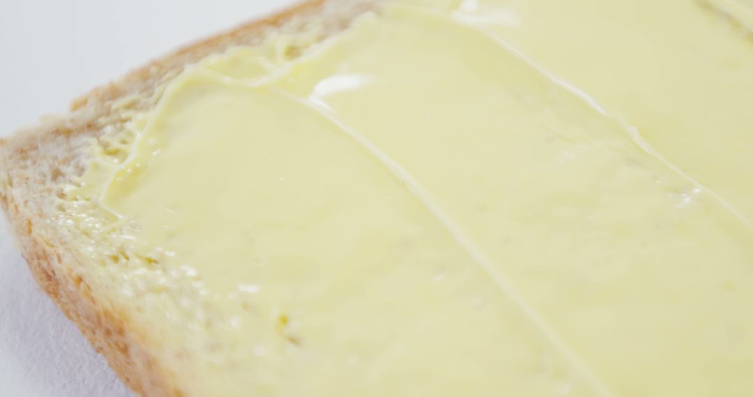 A close-up view of a slice of bread with a spread of butter, with copy space - Free Images, Stock Photos and Pictures on Pikwizard.com