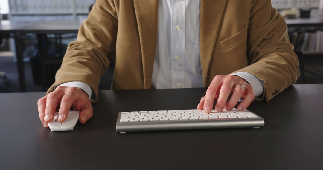 Business Professional Typing at Work Desk with Focus and Precision