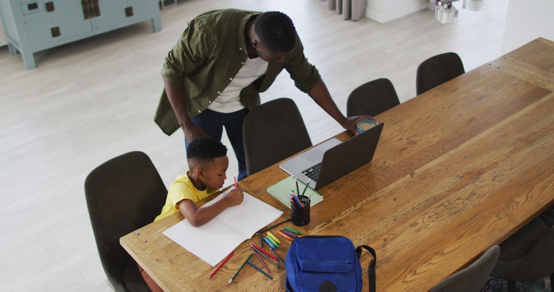 African American Father and Son Studying Together at Home During Quarantine - Free Images, Stock Photos and Pictures on Pikwizard.com