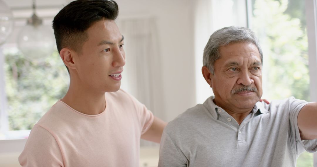 Young Man Supporting and Encouraging Elderly Father at Home - Free Images, Stock Photos and Pictures on Pikwizard.com