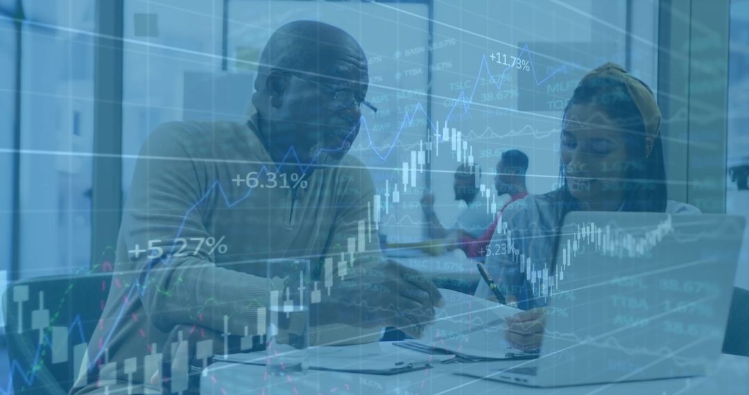 Multiethnic Colleagues Analyzing Digital Financial Data in Office Environment