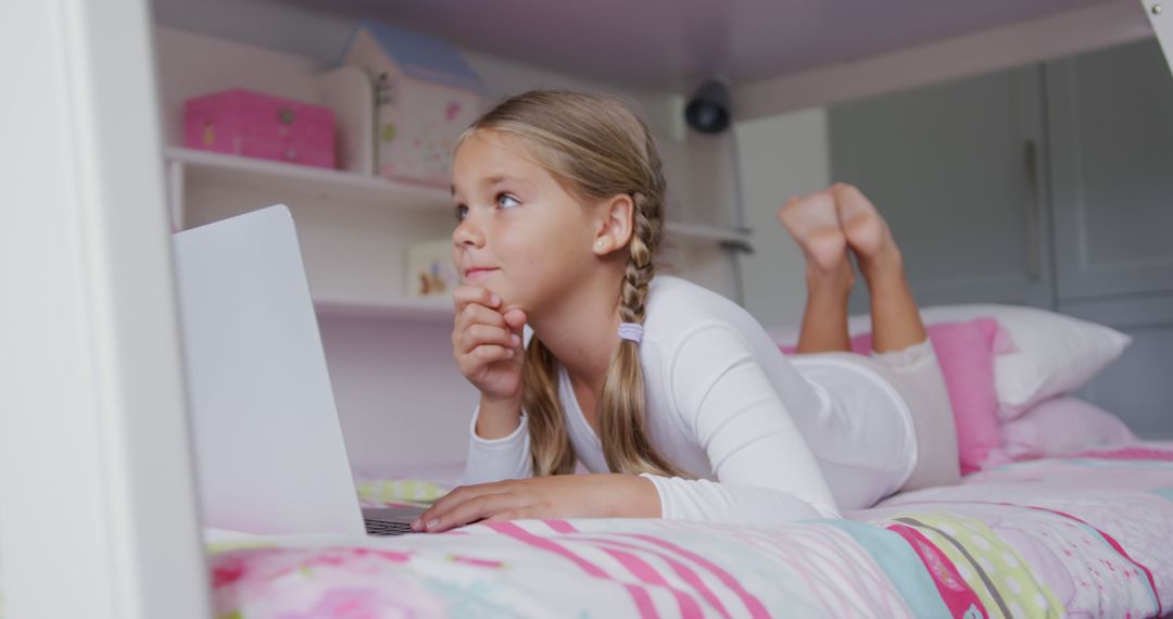 Young Girl Relaxing on Bed Using Laptop - Free Images, Stock Photos and Pictures on Pikwizard.com