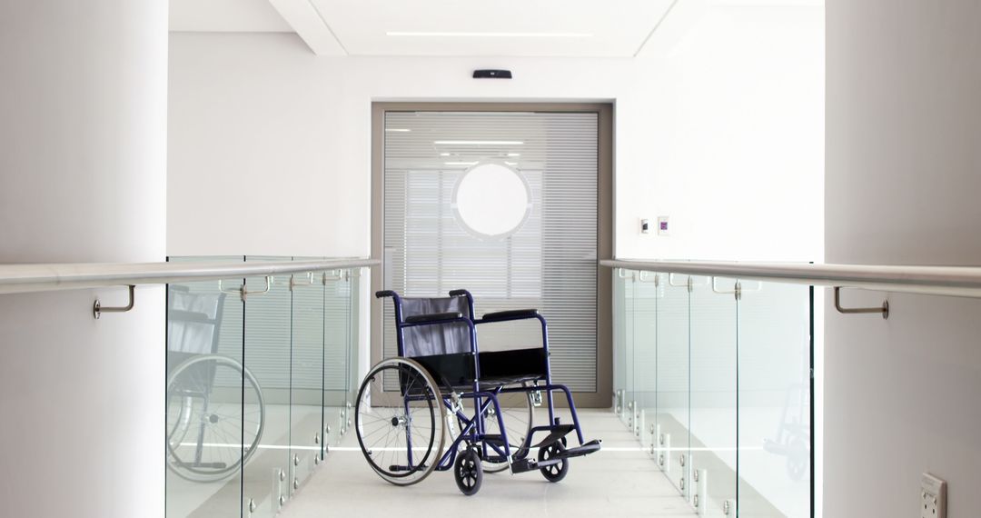 Empty Wheelchair in Bright Modern Hallway by Glass Railings - Free Images, Stock Photos and Pictures on Pikwizard.com