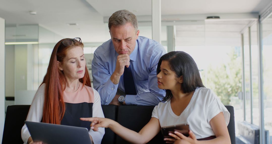 Diverse Business Colleagues Collaborate on Project in Office