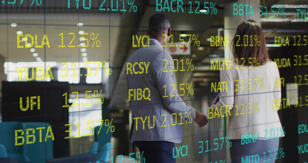 Finance Professionals Walking in Modern Office with Digital Stock Tickers