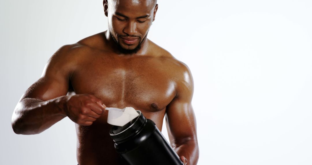 Athletic Man Preparing Protein Shake for Workout - Free Images, Stock Photos and Pictures on Pikwizard.com