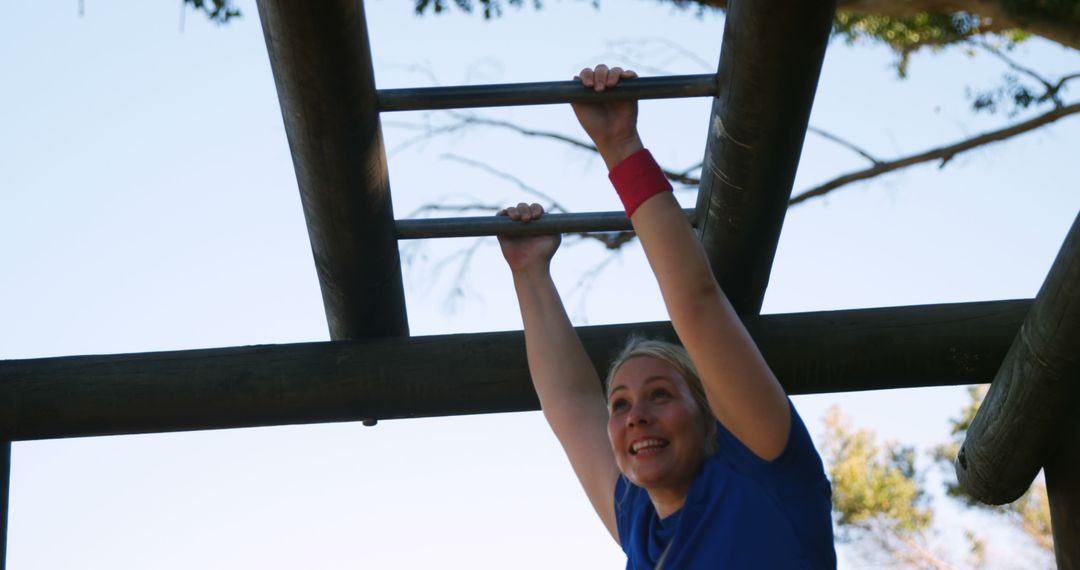 Happy Woman Exercising on Monkey Bars Outdoors - Free Images, Stock Photos and Pictures on Pikwizard.com