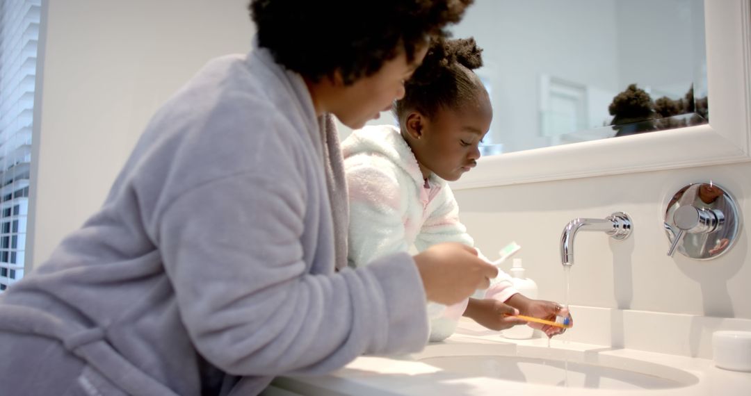 Mother Teaching Daughter to Brush Teeth in Bathroom - Free Images, Stock Photos and Pictures on Pikwizard.com