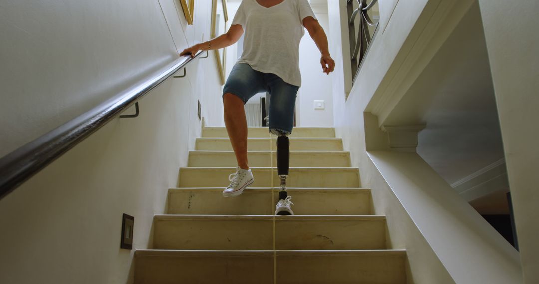 Person With Prosthetic Leg Descending Stairs at Home - Free Images, Stock Photos and Pictures on Pikwizard.com