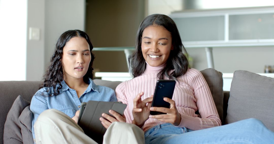 Diverse Friends Relaxing on Couch with Technology Devices