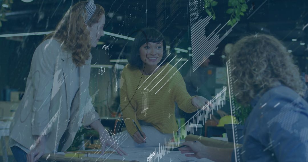 Three Professionals Collaborating on Digital Project in Open Plan Office