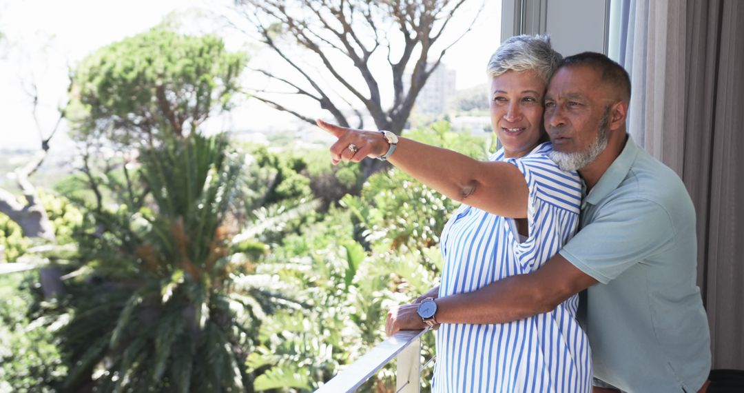 Mature Couple Enjoying Scenic View from Balcony on Sunny Day