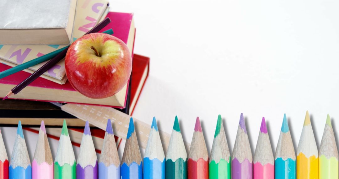 Colorful Pencils and School Books with Red Apple