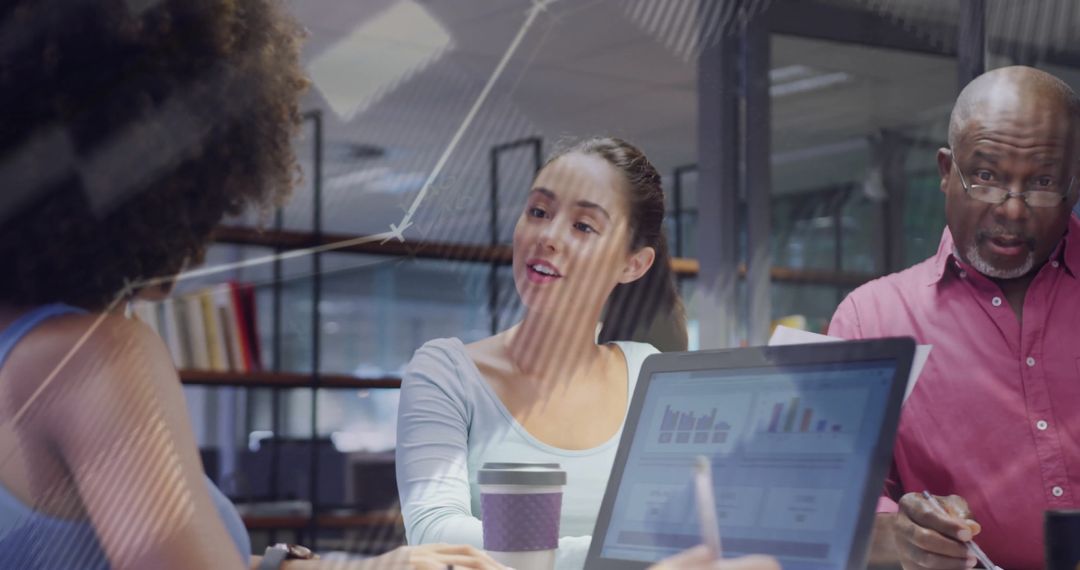 Team Discussing Data Insights in Modern Office Meeting