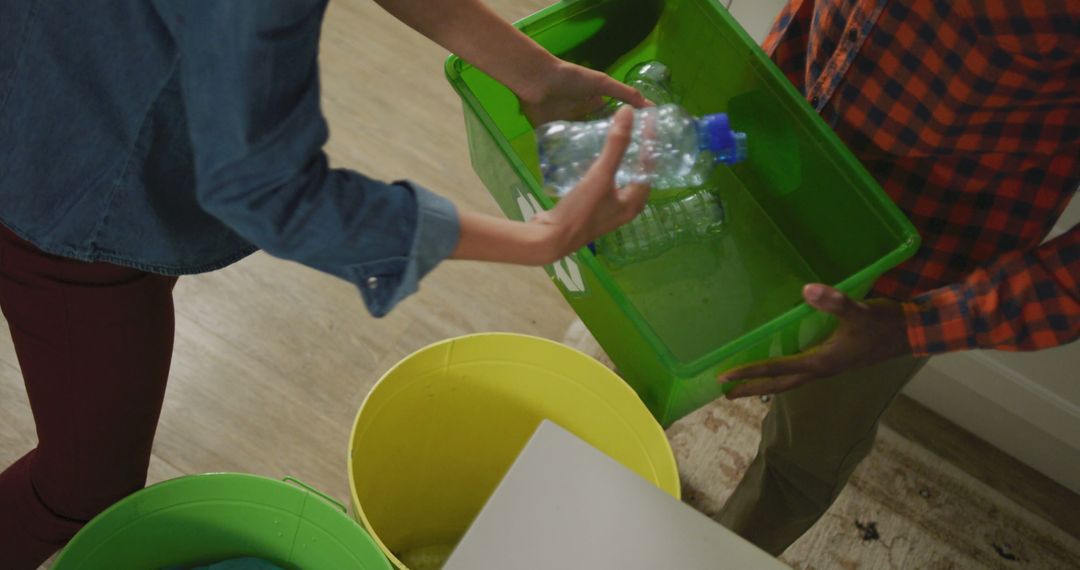 People Sorting Recyclable Plastic Bottles in Green Bin - Free Images, Stock Photos and Pictures on Pikwizard.com