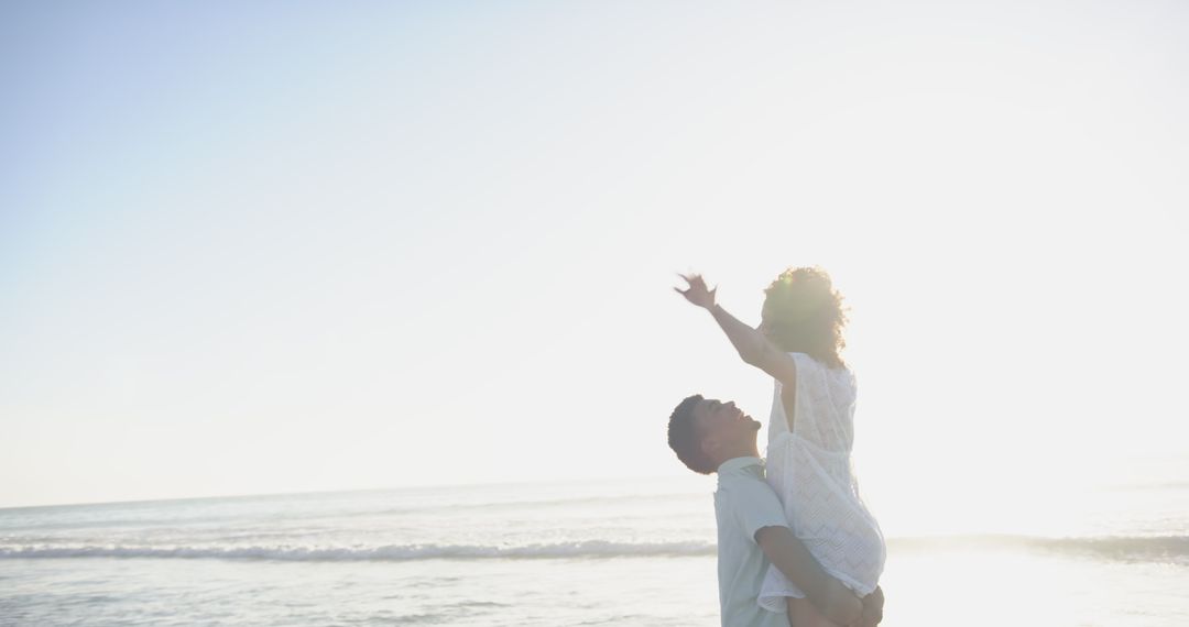 Joyful Couple Embracing Love in Serene Sunset Beach Silhouette