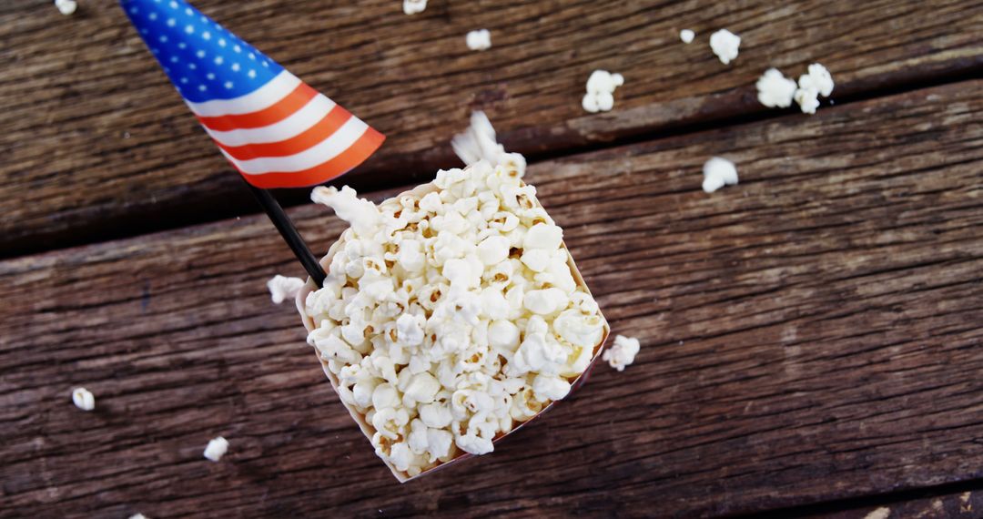 Patriotic popcorn with American flag on wooden background - Free Images, Stock Photos and Pictures on Pikwizard.com