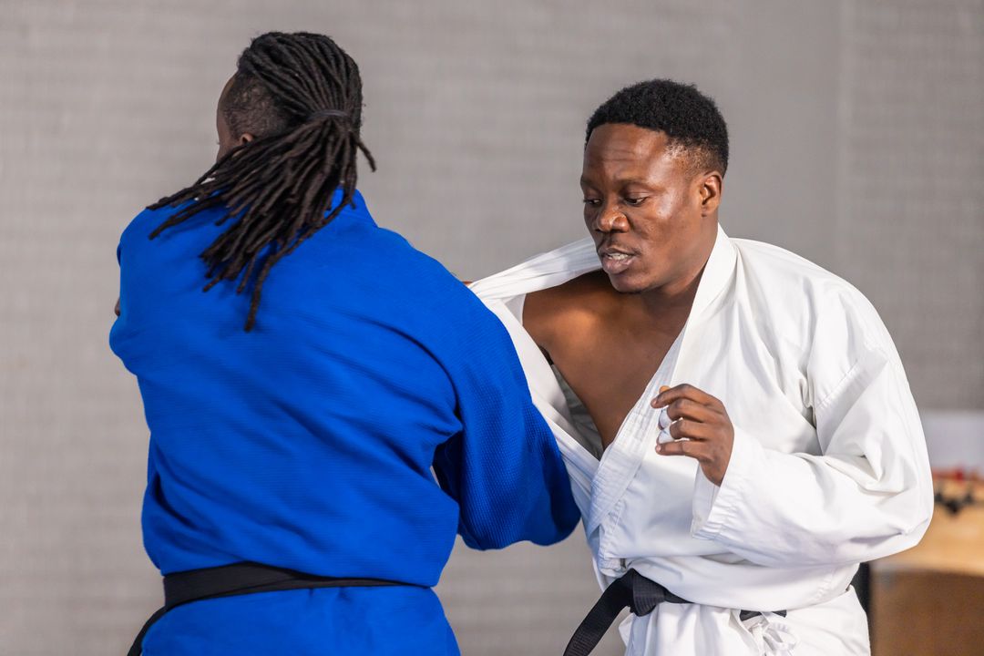 Martial Artists Sparring in Dojo Wearing Traditional Gis