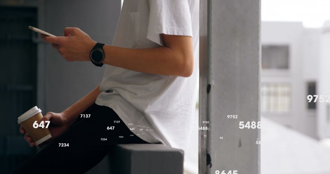 Young Adult Analyzing Data on Smartphone While Holding Coffee