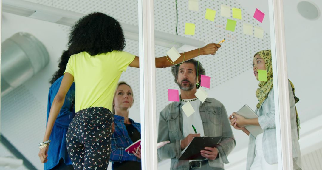 Diverse Team Collaborating on Creative Project with Sticky Notes