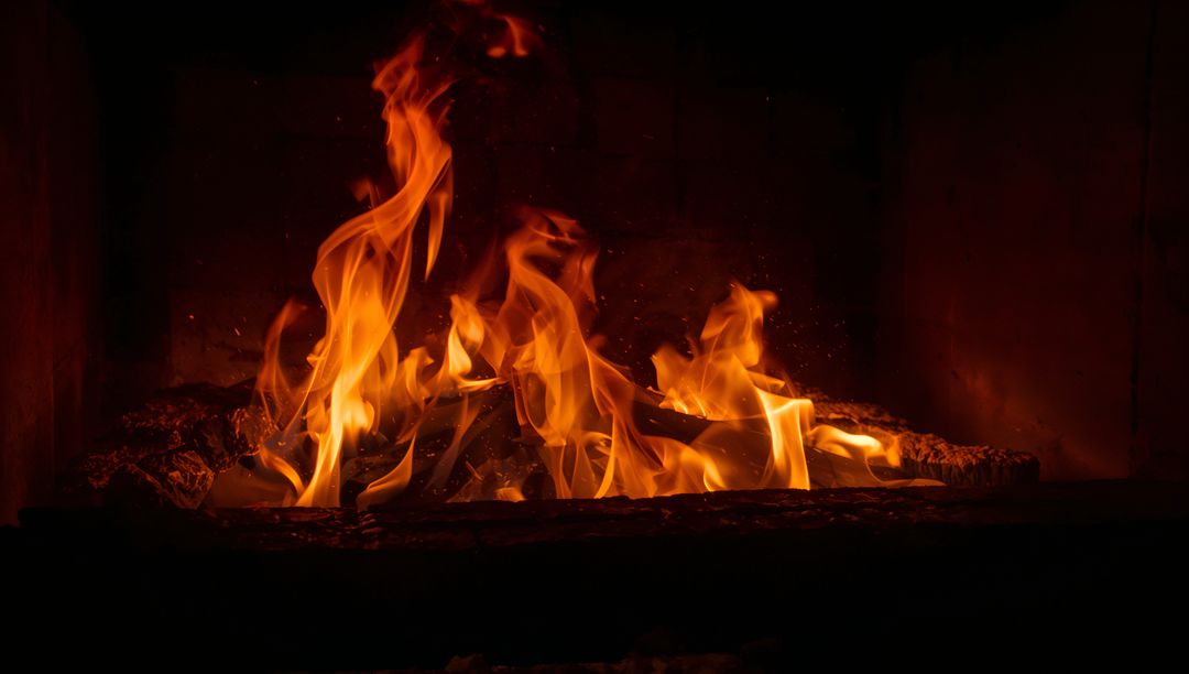 Rustic Fireplace Flames Burning Over Charred Logs with Amber Embers Cozy Hearth Glow
