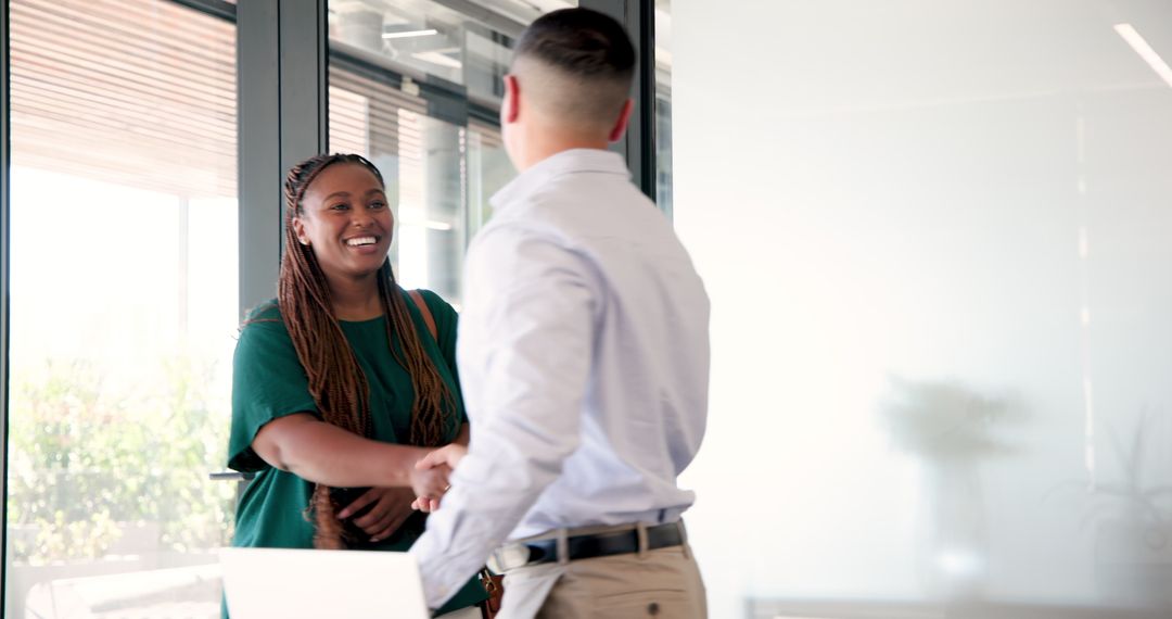 Colleagues Shaking Hands in Modern Office Workplace