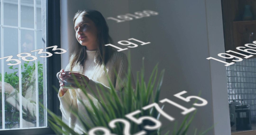 Holding mug and gazing through barred window with floating numbers overlay in cozy kitchen