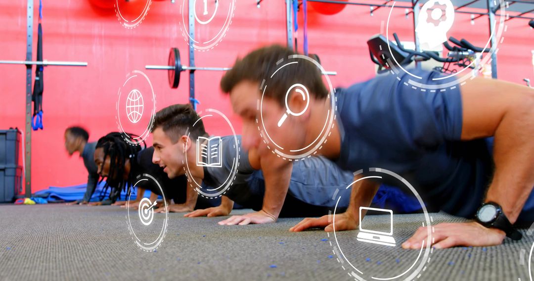 Men performing push-ups in gym during group strength training with digital icons