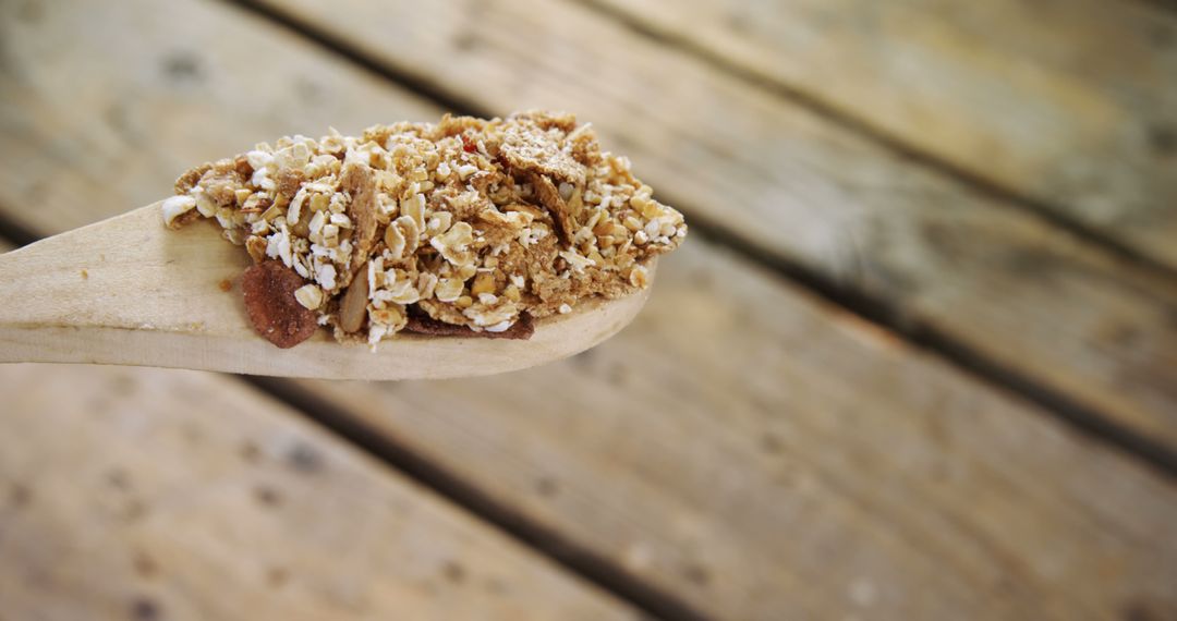 Freshly Made Granola Served on Wooden Spoon for Healthy Breakfast - Free Images, Stock Photos and Pictures on Pikwizard.com