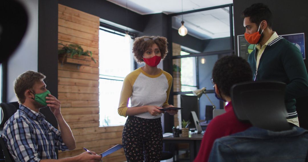 Team Collaborating in Office with Face Masks During Pandemic - Free Images, Stock Photos and Pictures on Pikwizard.com