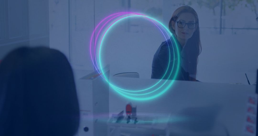 Woman in Glasses at Desk with Futuristic Holographic Interface