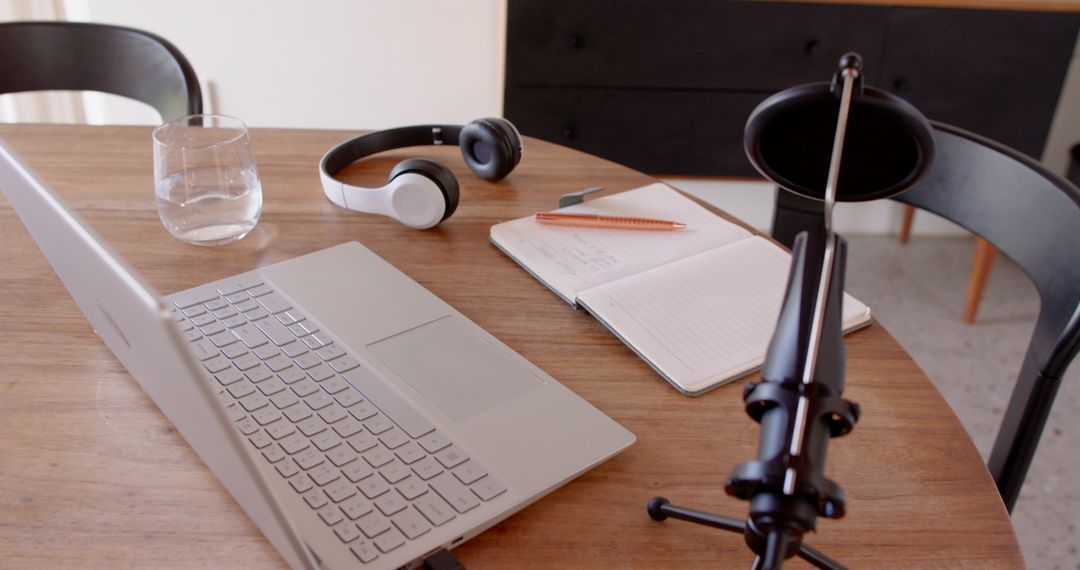 Modern Workspace with Laptop and Podcast Microphone
