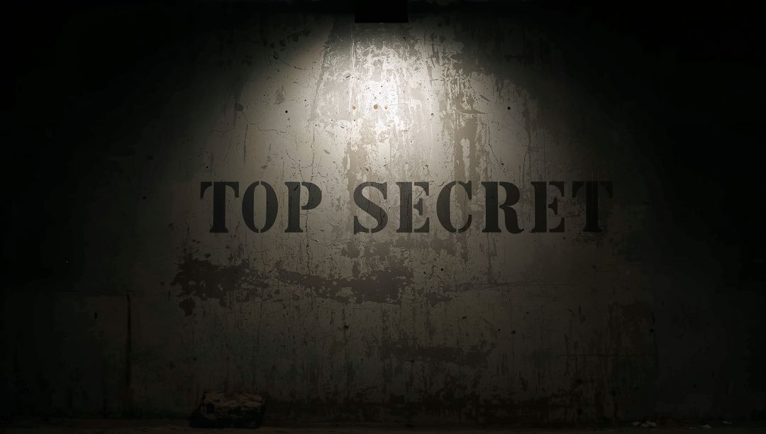 Top Secret Stencil On Weathered Concrete Wall Under Overhead Spotlight