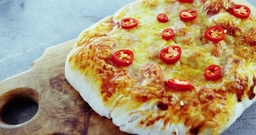 Close-Up of Homemade Cheese Pizza with Red Chilies on Wooden Board - Free Images, Stock Photos and Pictures on Pikwizard.com