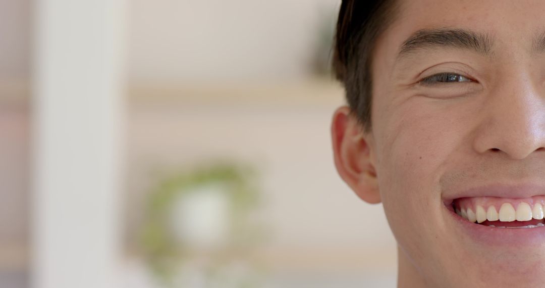 Half Face Portrait of Smiling Man in Bright Room