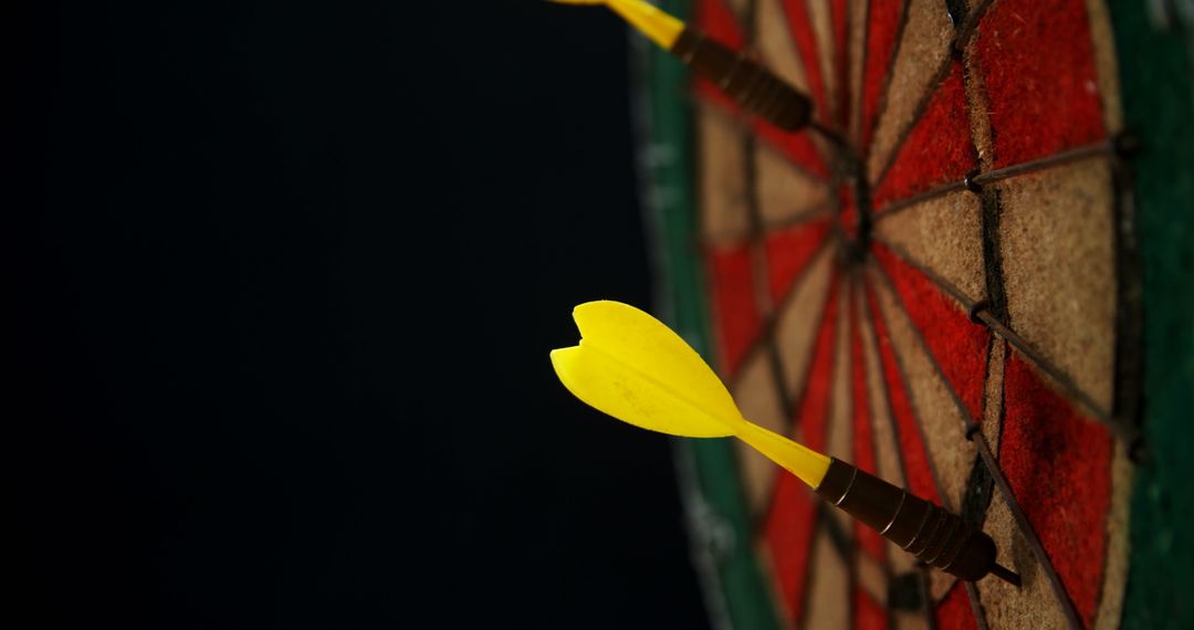 Yellow Darts Hitting Bulls-eye on Colorful Dartboard - Free Images, Stock Photos and Pictures on Pikwizard.com