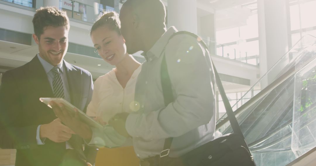Diverse Business Team Collaborating in Sunlit Office Atrium