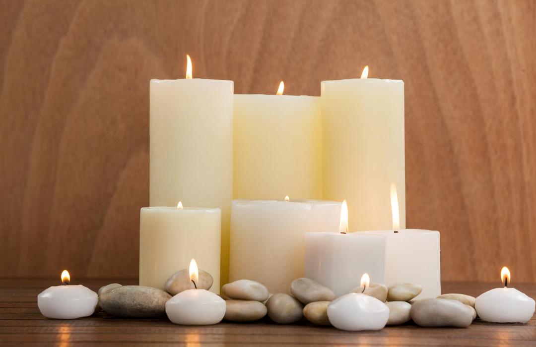 White candles and pebbles stone on wood - Free Images, Stock Photos and Pictures on Pikwizard.com