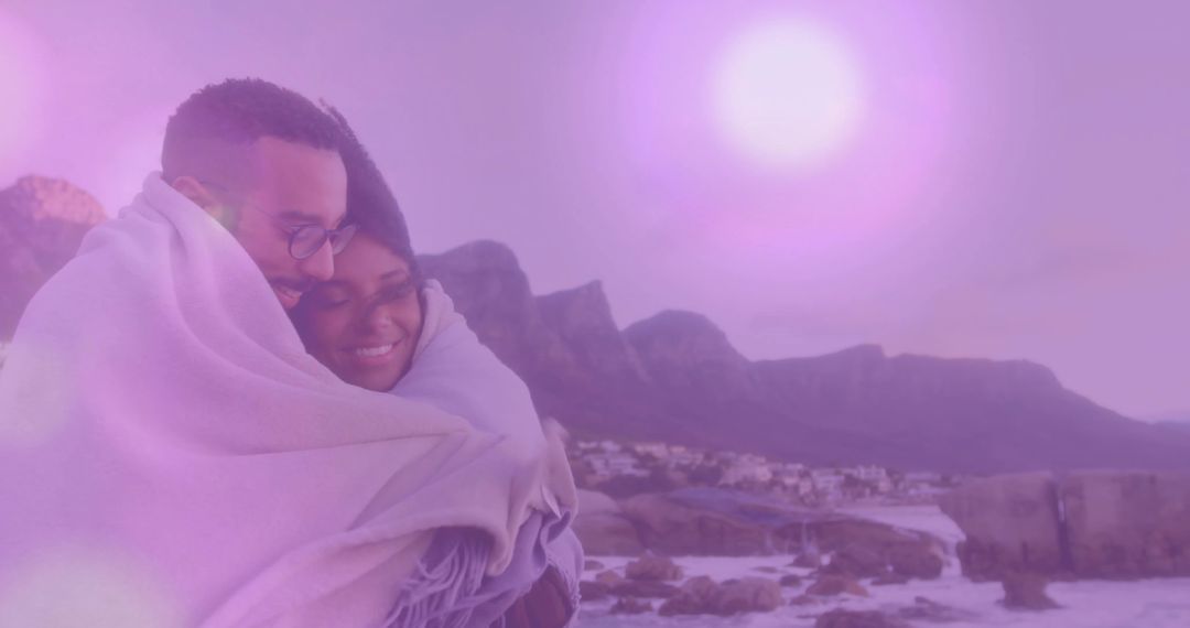 Couple Wrapped in Blanket Enjoying Romantic Waterfront View