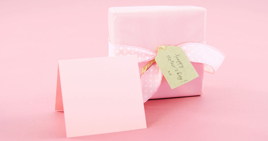 A Mother's Day themed pink gift box with a white ribbon symbolizes traditional holiday warmth. - Free Images, Stock Photos and Pictures on Pikwizard.com