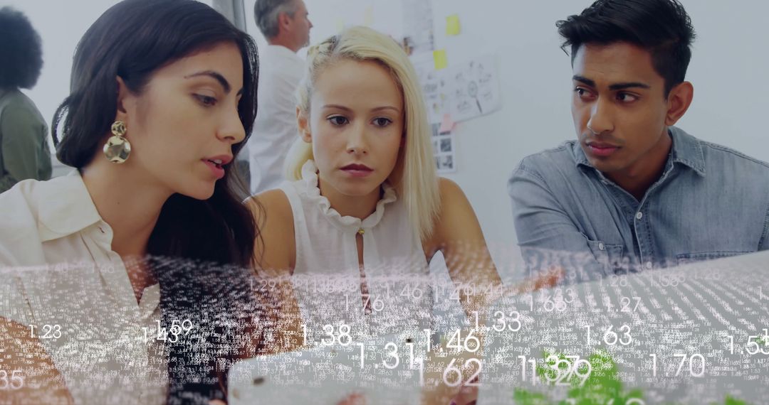 Focused Team Collaborating on Digital Data in Modern Office