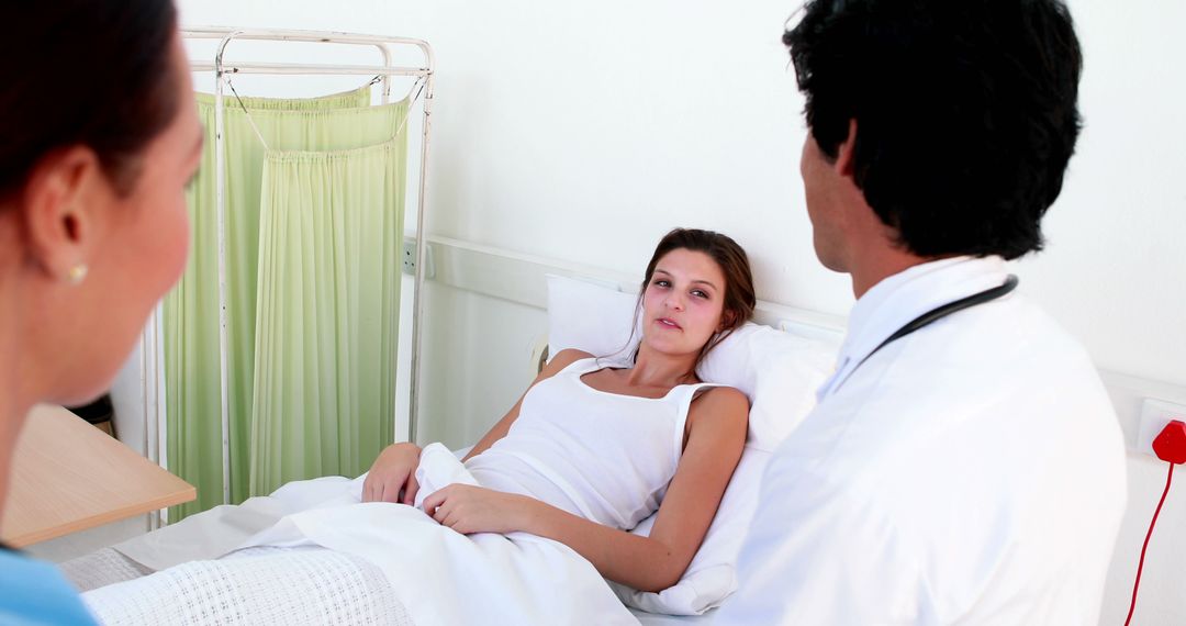 Doctor and Nurse Attending to Young Female Patient in Hospital Bed - Free Images, Stock Photos and Pictures on Pikwizard.com