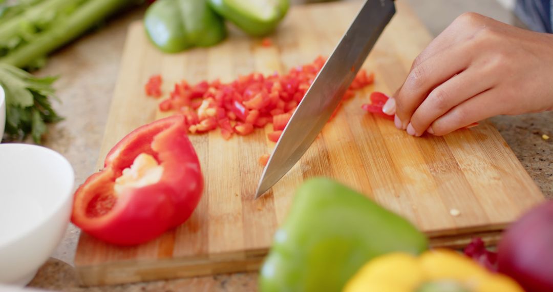 Hands Chopping Red Bell Peppers on Wooden Cutting Board - Free Images, Stock Photos and Pictures on Pikwizard.com