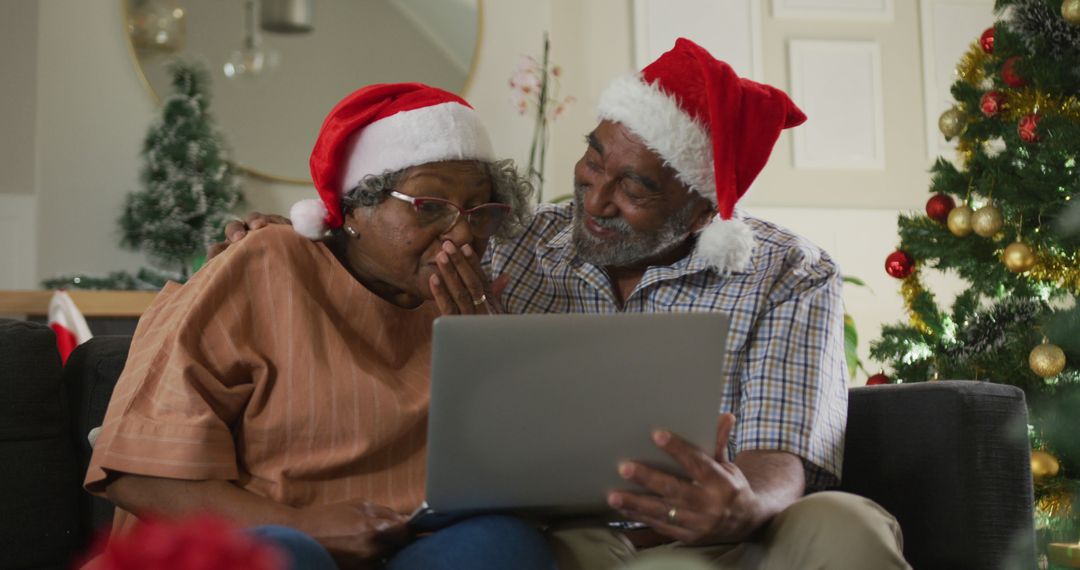 Image of happy african american senior couple having image call at christmas time - Free Images, Stock Photos and Pictures on Pikwizard.com