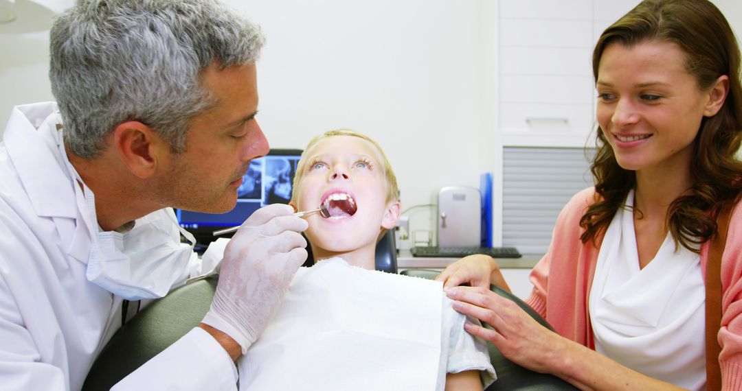 Dentist examining young patient with dental tool at dental clinic 4k - Free Images, Stock Photos and Pictures on Pikwizard.com