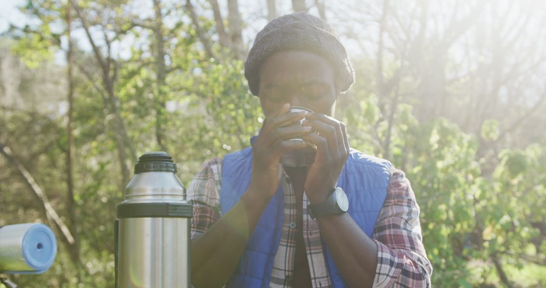 Man Enjoying Hot Drink Outdoors in Forest - Free Images, Stock Photos and Pictures on Pikwizard.com