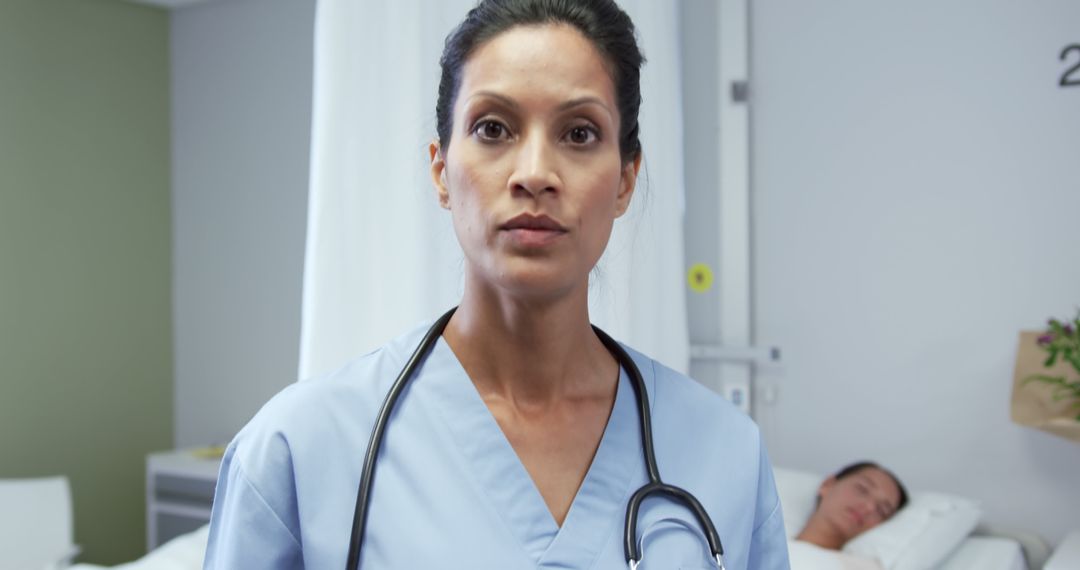 Concerned Doctor in Hospital Room With Patient in Background - Free Images, Stock Photos and Pictures on Pikwizard.com